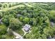 Stunning aerial view of private home surrounded by lush trees and verdant golf course at 1805 Wood Valley Dr, Carmel, IN 46032