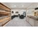 Basement includes theater room and kitchenette with wood-accent wall at 1805 Wood Valley Dr, Carmel, IN 46032