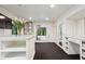 Bright bathroom features white cabinetry, marble counters, dual vanities, and an open doorway to an adjacent room at 1805 Wood Valley Dr, Carmel, IN 46032