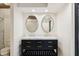 Bathroom with dual oval mirrors, marble countertop, and black vanity at 1805 Wood Valley Dr, Carmel, IN 46032