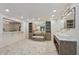 Large bathroom with double sinks, herringbone tile floors and bench seating at 1805 Wood Valley Dr, Carmel, IN 46032