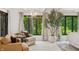 Cozy bedroom with armchairs, tree, and bright view at 1805 Wood Valley Dr, Carmel, IN 46032