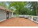Spacious wooden deck with outdoor seating, perfect for enjoying the surrounding green trees and scenic views at 1805 Wood Valley Dr, Carmel, IN 46032