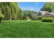 Beautiful home with large lawn, mature trees, and classic architectural details at 1805 Wood Valley Dr, Carmel, IN 46032
