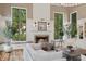 Cozy living room fireplace framed by large windows and comfortable seating at 1805 Wood Valley Dr, Carmel, IN 46032