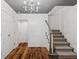 Inviting foyer with hardwood floors, staircase, wainscoting, and a modern chandelier creating a grand entrance at 1805 Wood Valley Dr, Carmel, IN 46032