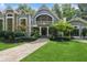 Inviting front entrance with a stone walkway, mature trees, and meticulously maintained landscaping at 1805 Wood Valley Dr, Carmel, IN 46032