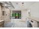 Modern laundry room featuring tile floors, walk-in shower, and backyard view at 1805 Wood Valley Dr, Carmel, IN 46032