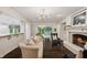 Cozy living room with fireplace, hardwood floors, and a large opening to other living spaces at 1805 Wood Valley Dr, Carmel, IN 46032