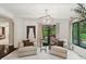 Bright sitting room featuring white wood paneling, modern light fixture, and outdoor access at 1805 Wood Valley Dr, Carmel, IN 46032