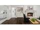 Elegant living room featuring fireplace, dark wood floors, and access to the Primary bedroom at 1805 Wood Valley Dr, Carmel, IN 46032