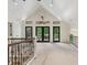 Bright loft space featuring tall ceilings, large windows, and a view of the outdoor scenery at 1805 Wood Valley Dr, Carmel, IN 46032