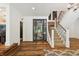 Elegant staircase with hardwood steps and white risers, leading to the upper level at 1805 Wood Valley Dr, Carmel, IN 46032