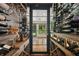 Climate-controlled wine cellar with custom shelving and ample storage for wine collection at 1805 Wood Valley Dr, Carmel, IN 46032
