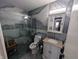 Modern bathroom features beautiful gray tilework, a glass shower, and updated fixtures at 1823 Long Lake Dr, Greenwood, IN 46143