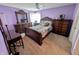 Bedroom with lavender walls, carpet, ornate furniture, and natural light from a window at 1823 Long Lake Dr, Greenwood, IN 46143