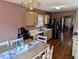 Eat-in kitchen with light-colored cabinets, wood flooring, and stainless steel appliances at 1823 Long Lake Dr, Greenwood, IN 46143