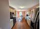Functional kitchen with wood floors and stainless steel appliances, leading to a dining area at 1823 Long Lake Dr, Greenwood, IN 46143