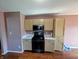 Well-lit kitchen with wooden cabinets and modern black appliances and ample counter space at 1823 Long Lake Dr, Greenwood, IN 46143