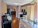 Eat-in kitchen with stainless appliances and wood flooring open to the living room at 1823 Long Lake Dr, Greenwood, IN 46143