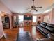Open-concept living room with wood floors, sectional seating, and large windows at 1823 Long Lake Dr, Greenwood, IN 46143