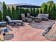 Outdoor patio with ample seating, an umbrella, and a grill surrounded by lush greenery at 1823 Long Lake Dr, Greenwood, IN 46143