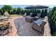 Backyard patio area complete with wicker furniture set, shade umbrella, and a barbeque grill at 1823 Long Lake Dr, Greenwood, IN 46143