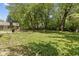 Large backyard featuring mature trees, a playset, and plenty of space for outdoor activities at 1930 Bechtel Rd, Indianapolis, IN 46260