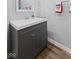 Bathroom featuring a gray vanity with brushed nickel hardware and decorative patriotic towels at 1930 Bechtel Rd, Indianapolis, IN 46260