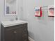 Modern bathroom featuring a gray vanity with brushed nickel hardware and decorative patriotic towels at 1930 Bechtel Rd, Indianapolis, IN 46260