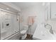 Bathroom features a walk-in shower, a toilet, and double sinks with bright lighting at 1930 Bechtel Rd, Indianapolis, IN 46260