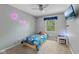 Cozy bedroom with gray walls, plush carpet, tv, and a Paw Patrol themed bedspread at 1930 Bechtel Rd, Indianapolis, IN 46260