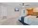 Bedroom with carpeted floors, a custom closet with a built-in dresser, and a mounted TV at 1930 Bechtel Rd, Indianapolis, IN 46260