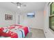 Bright bedroom featuring a ceiling fan, carpeted floors, and a wall-mounted TV at 1930 Bechtel Rd, Indianapolis, IN 46260