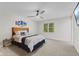 Neutral bedroom featuring carpeted flooring, a window for natural light, and a ceiling fan at 1930 Bechtel Rd, Indianapolis, IN 46260