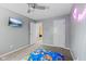 Clean bedroom with neutral gray walls, tv, ceiling fan and carpet at 1930 Bechtel Rd, Indianapolis, IN 46260