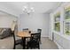 Bright dining room features an oval wood table, black chairs, and a window letting in natural light at 1930 Bechtel Rd, Indianapolis, IN 46260
