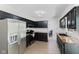Updated kitchen features stainless steel appliances, dark cabinets, butcher block countertops, and subway tile backsplash at 1930 Bechtel Rd, Indianapolis, IN 46260