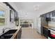 This kitchen features stainless steel appliances, dark cabinets, butcher block counters, and an opening to the living room at 1930 Bechtel Rd, Indianapolis, IN 46260