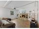 Bright living room features white walls, wood beam ceilings, stone fireplace, and comfortable seating at 1930 Bechtel Rd, Indianapolis, IN 46260