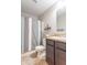 Bathroom with dark wood vanity and bronze countertop featuring neutral wall paint and tiled flooring at 19555 Kailey Way, Noblesville, IN 46062