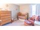 Bedroom room with wood crib, chest of drawers and comfortable chair in a brightly lit area at 19555 Kailey Way, Noblesville, IN 46062