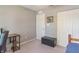 Bedroom with neutral carpet and wall paint, closet and black leather ottoman on a neutral rug at 19555 Kailey Way, Noblesville, IN 46062