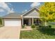 Charming single Gathering home showcasing a manicured lawn and inviting front porch at 19555 Kailey Way, Noblesville, IN 46062