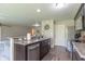 Well-lit kitchen with granite countertops, stainless steel appliances, and dark wood cabinetry at 19555 Kailey Way, Noblesville, IN 46062