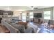 Open concept living area with a large sectional sofa, adjoining kitchen, and sliding glass doors at 19555 Kailey Way, Noblesville, IN 46062