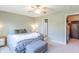 Relaxing bedroom with a cozy bed, ceiling fan, and an adjacent closet space at 19555 Kailey Way, Noblesville, IN 46062
