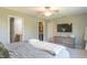 Well-lit bedroom with a ceiling fan, closet, and a dresser at 19555 Kailey Way, Noblesville, IN 46062