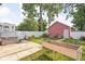 Private backyard featuring a hot tub, a wooden planter box, and a detached garage at 2015 N College Ave, Indianapolis, IN 46202