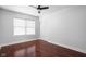 An empty bedroom featuring wood floors, a window, and a closet at 2015 N College Ave, Indianapolis, IN 46202